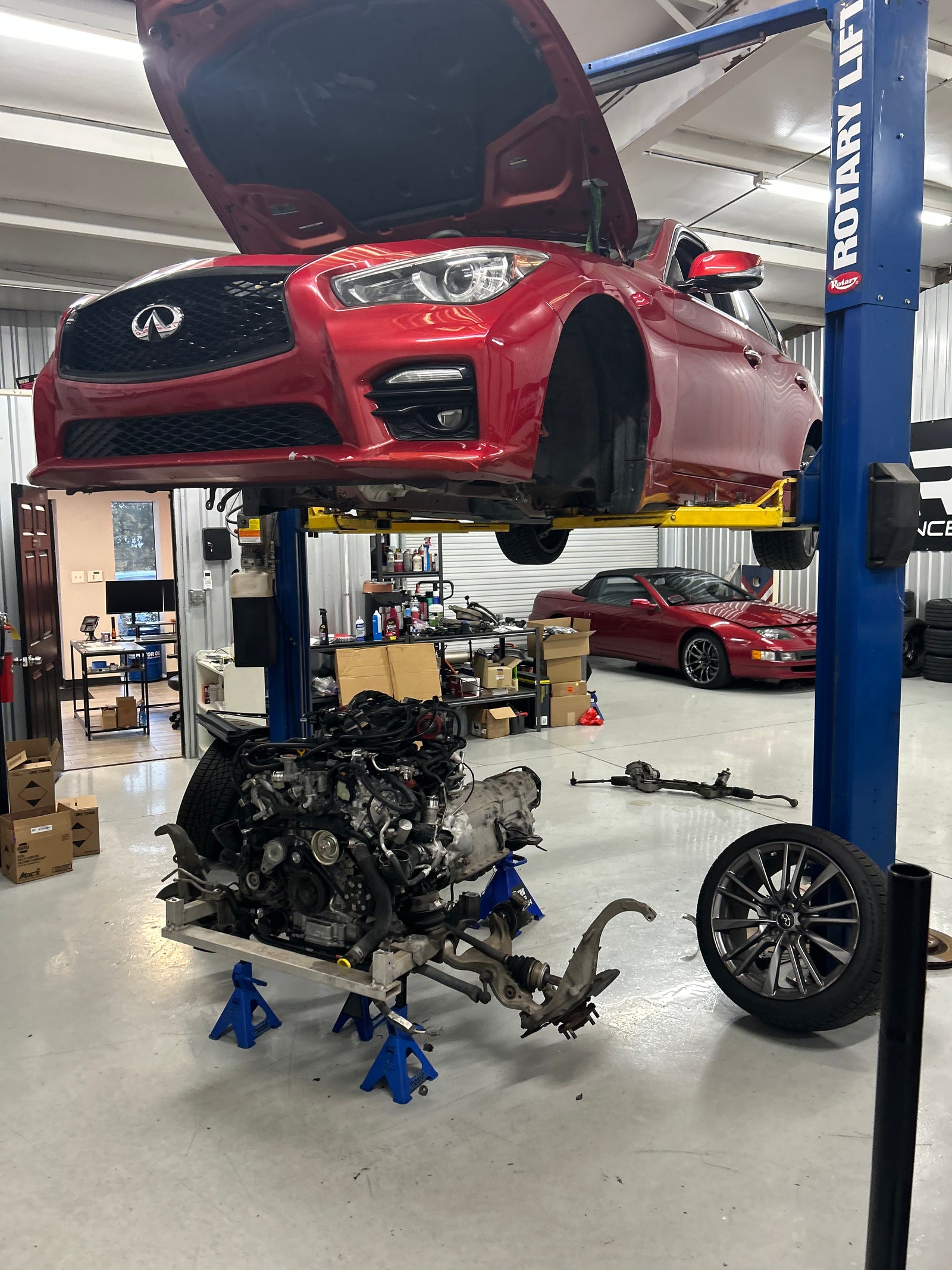 VR30-equipped Infiniti Q50 on a lift during engine-out service