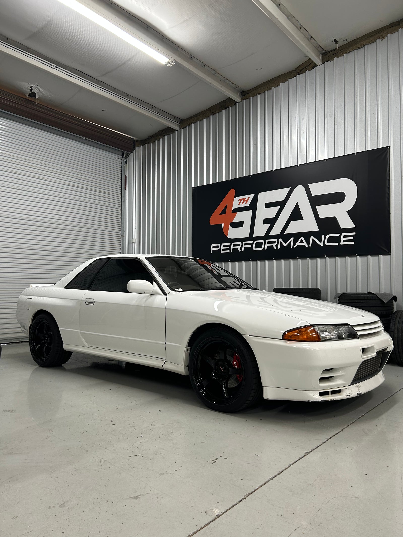 White R32 Skyline parked inside the 4th Gear Performance workshop