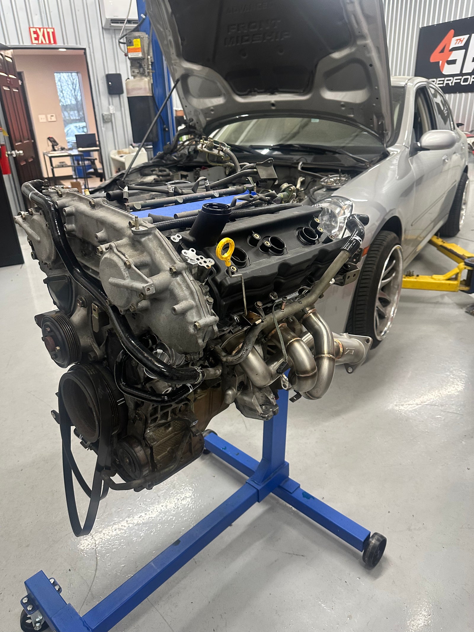 VQ35 engine removed from the vehicle, with exhaust headers visible